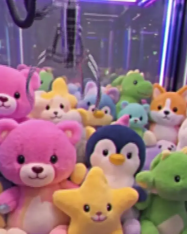 A claw machine full of plush toys